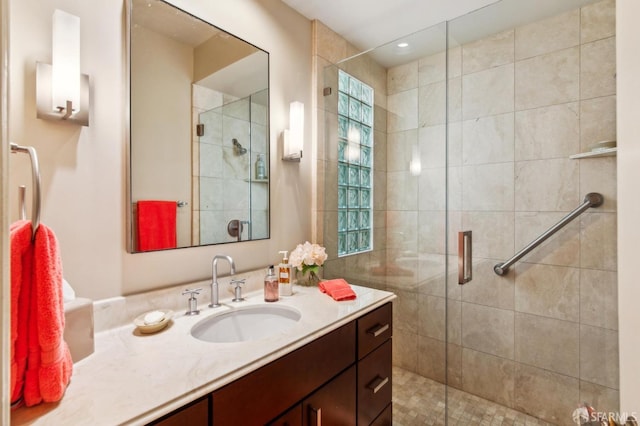 full bathroom featuring a stall shower and vanity