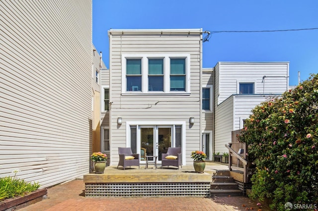 rear view of house featuring a deck