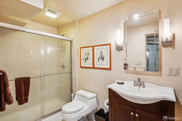 full bathroom with vanity, toilet, and a shower stall