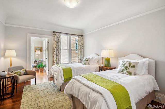 bedroom with crown molding and dark wood-type flooring