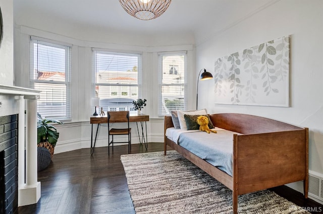 living area featuring a brick fireplace and dark parquet flooring