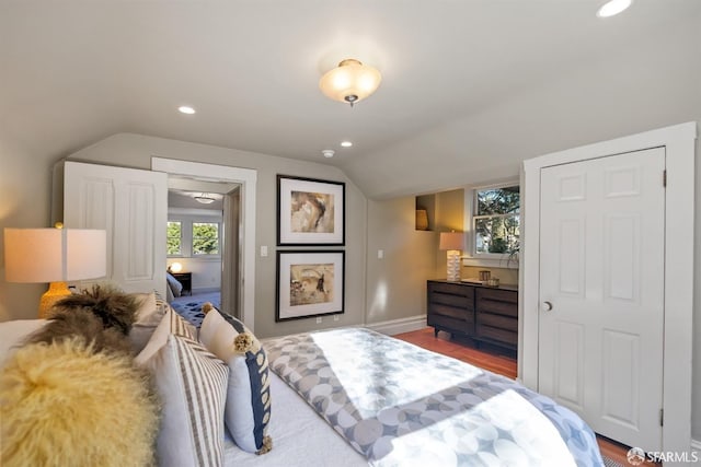 bedroom with hardwood / wood-style floors and vaulted ceiling