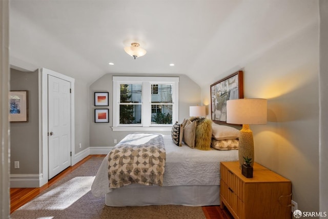 bedroom featuring vaulted ceiling and hardwood / wood-style floors