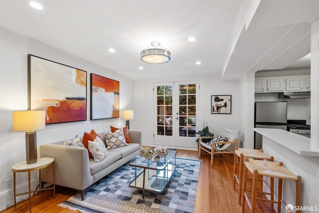 living room featuring french doors and light wood-type flooring