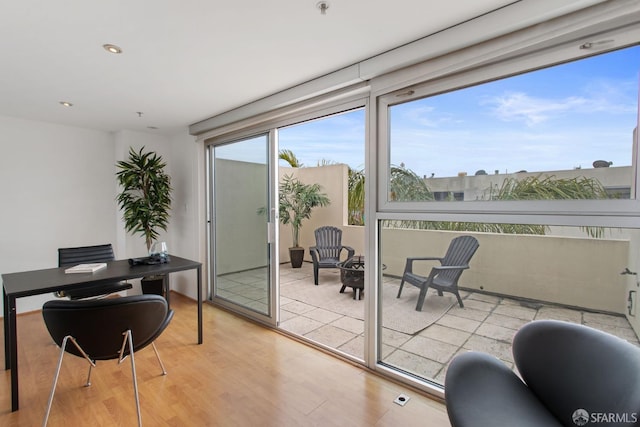 doorway to outside with light wood-style flooring and recessed lighting