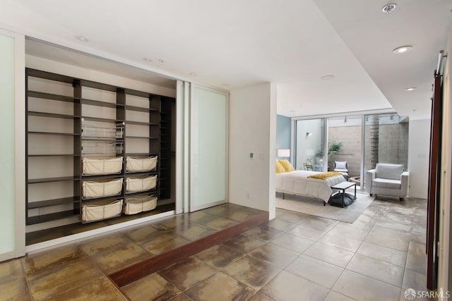 tiled bedroom featuring floor to ceiling windows and recessed lighting