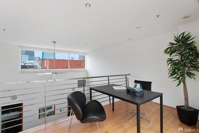 office featuring recessed lighting, a city view, and wood finished floors