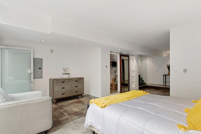 bedroom with a barn door, electric panel, and recessed lighting