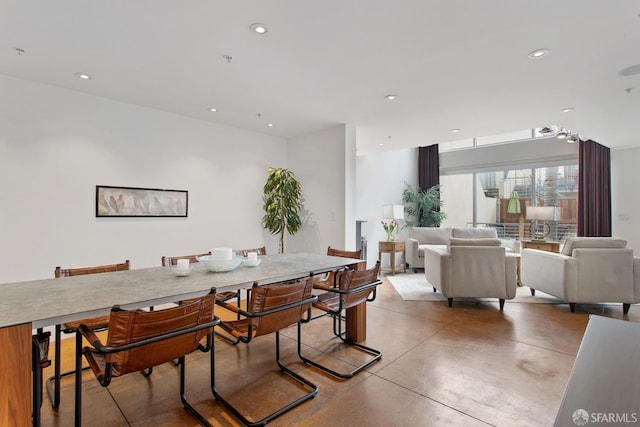 dining area with finished concrete flooring and recessed lighting