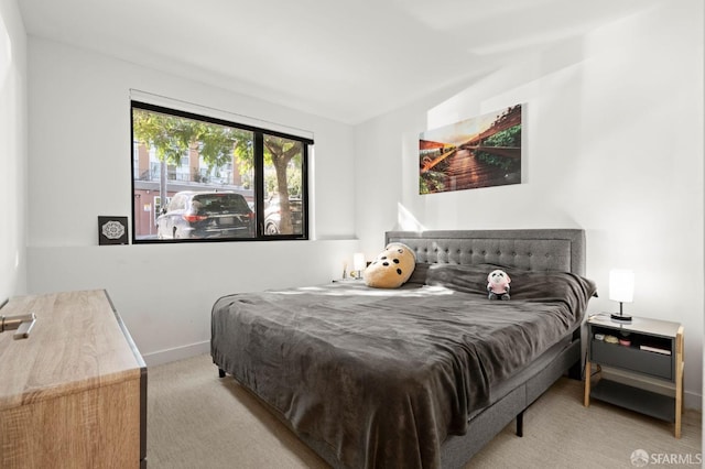 bedroom featuring baseboards and carpet flooring