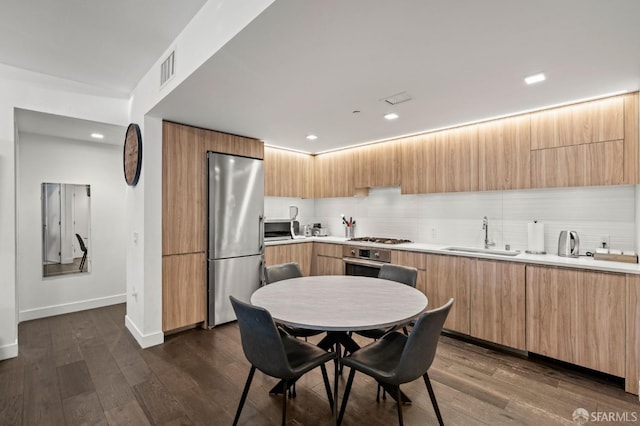 kitchen featuring appliances with stainless steel finishes, modern cabinets, and a sink