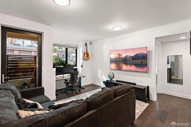 living room featuring baseboards and dark wood-style flooring