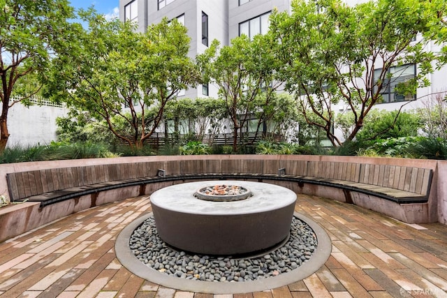 deck with a patio area and an outdoor fire pit