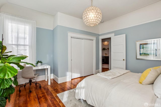 bedroom featuring dark hardwood / wood-style floors and a chandelier