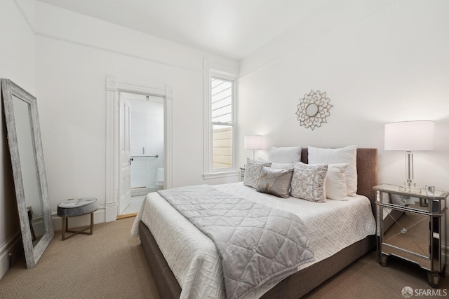 bedroom featuring carpet flooring and connected bathroom
