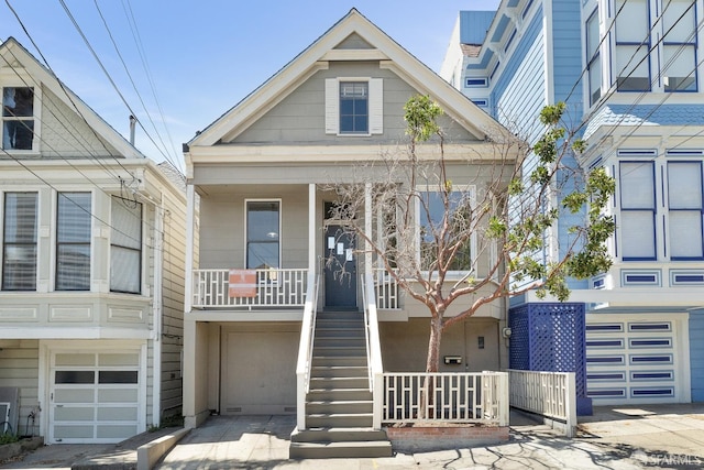 view of front of property featuring an attached garage, covered porch, and stairs