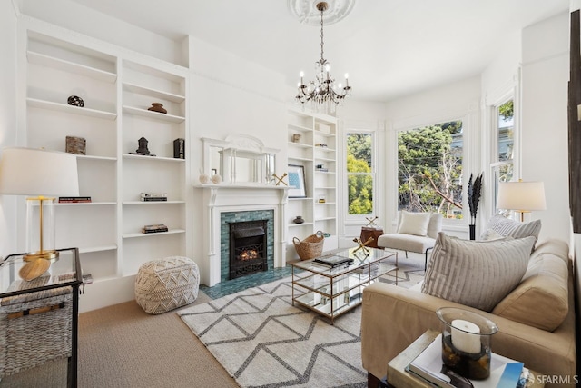carpeted living room featuring a warm lit fireplace, built in features, and a chandelier