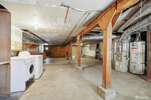 unfinished basement featuring washer and clothes dryer, secured water heater, and heating unit