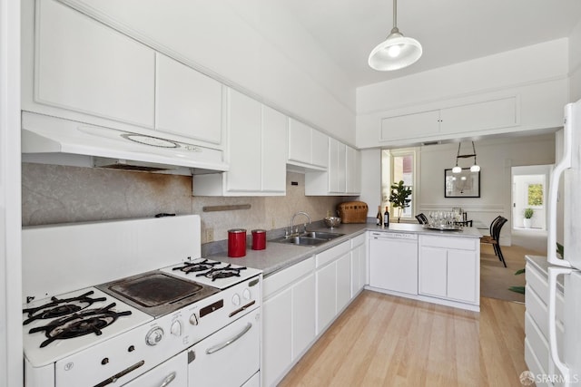 kitchen with white appliances, a sink, under cabinet range hood, light wood-style flooring, and white cabinetry