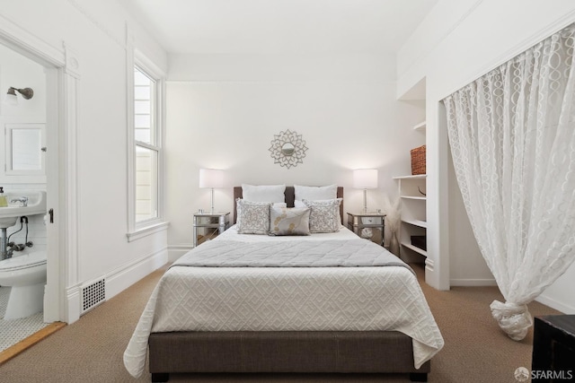 carpeted bedroom featuring baseboards