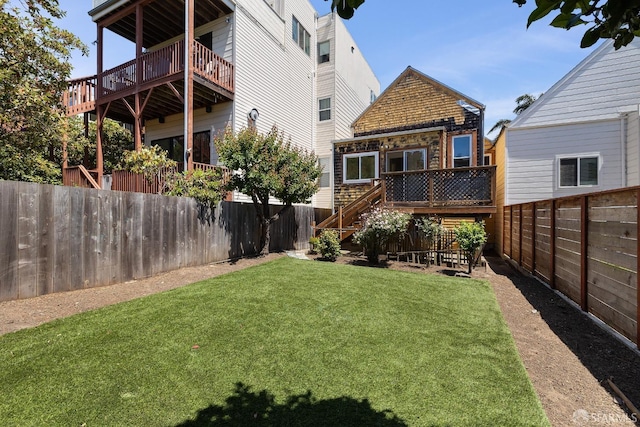 view of yard with a wooden deck and stairway