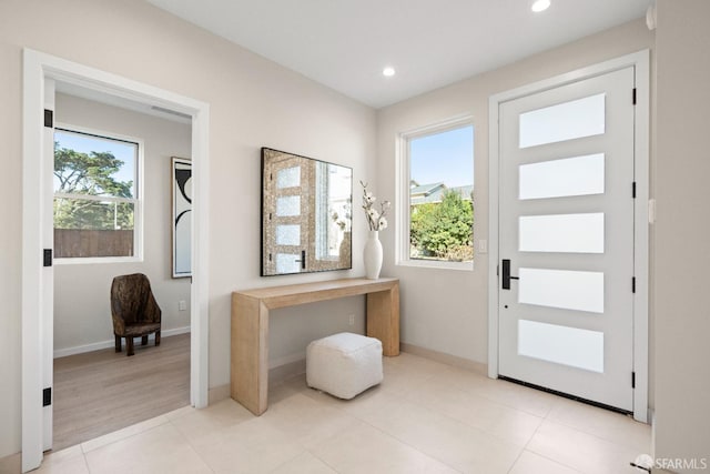 doorway to outside with a wealth of natural light and light hardwood / wood-style flooring