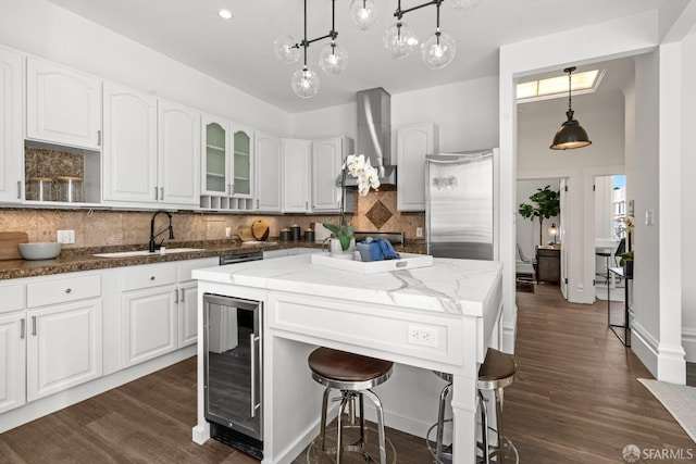 115 Magnolia St, San Francisco, CA 94123 - kitchen with a sink, dark stone countertops, white cabinetry, tasteful backsplash, and wine cooler