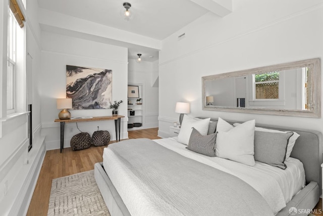 115 Magnolia St, San Francisco, CA 94123 - bedroom with beamed ceiling, visible vents, and wood finished floors