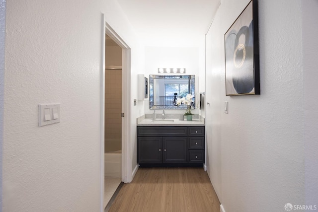 hall featuring sink and light hardwood / wood-style flooring