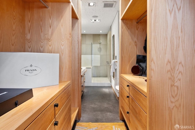 bathroom featuring vanity, toilet, concrete floors, and walk in shower