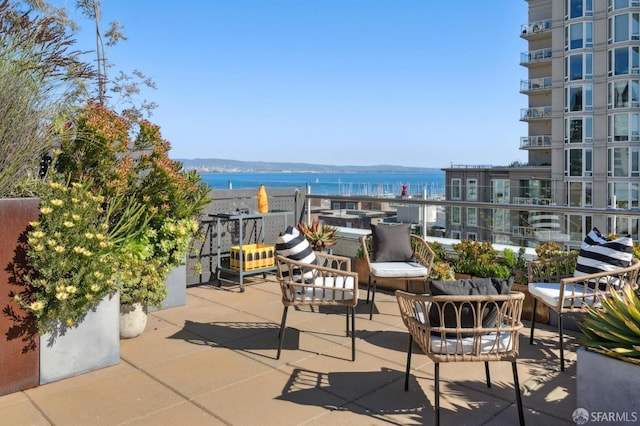 view of patio featuring an outdoor hangout area and a water view