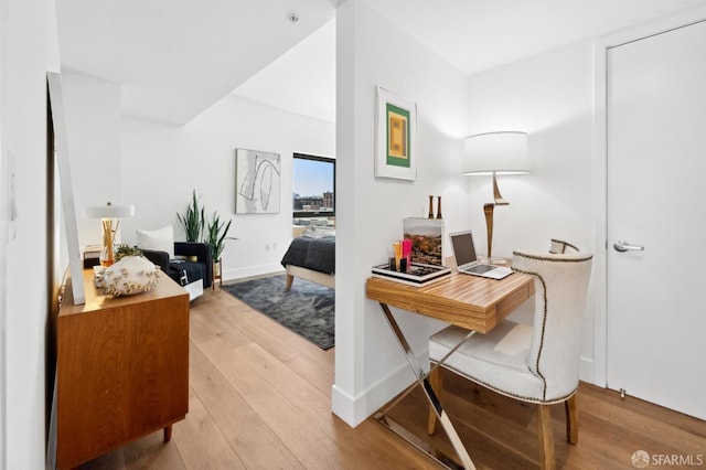 office area featuring baseboards and wood finished floors