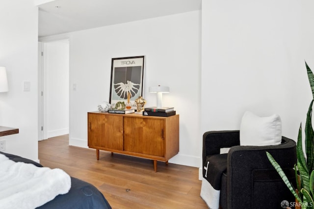 living area with wood finished floors and baseboards