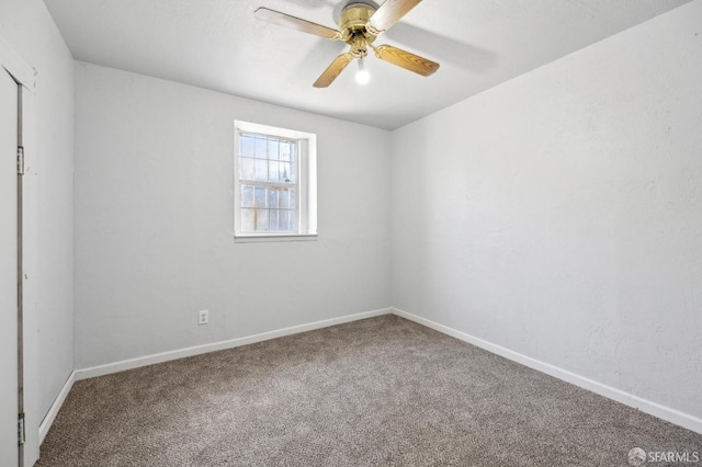 carpeted empty room with baseboards and ceiling fan