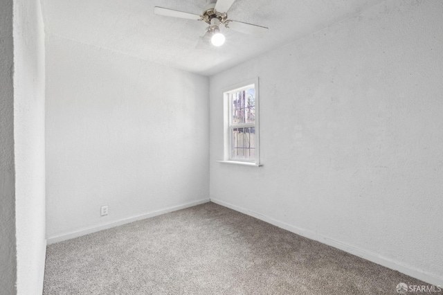 unfurnished room featuring carpet flooring, a ceiling fan, and baseboards