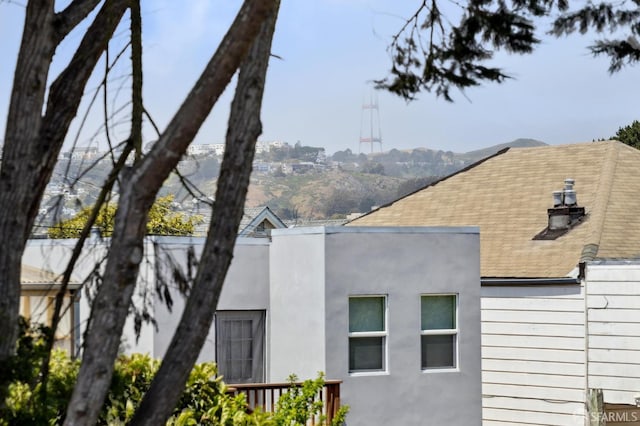 view of side of home featuring a shingled roof