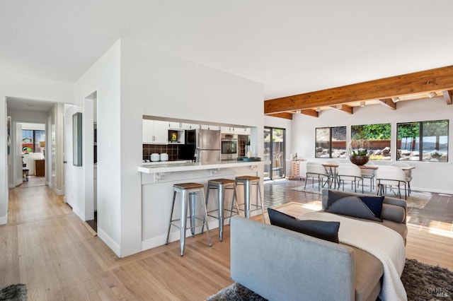308 E Strawberry Dr, Mill Valley, CA 94941 - living room featuring healthy amount of natural light, light wood-style flooring, baseboards, and beam ceiling
