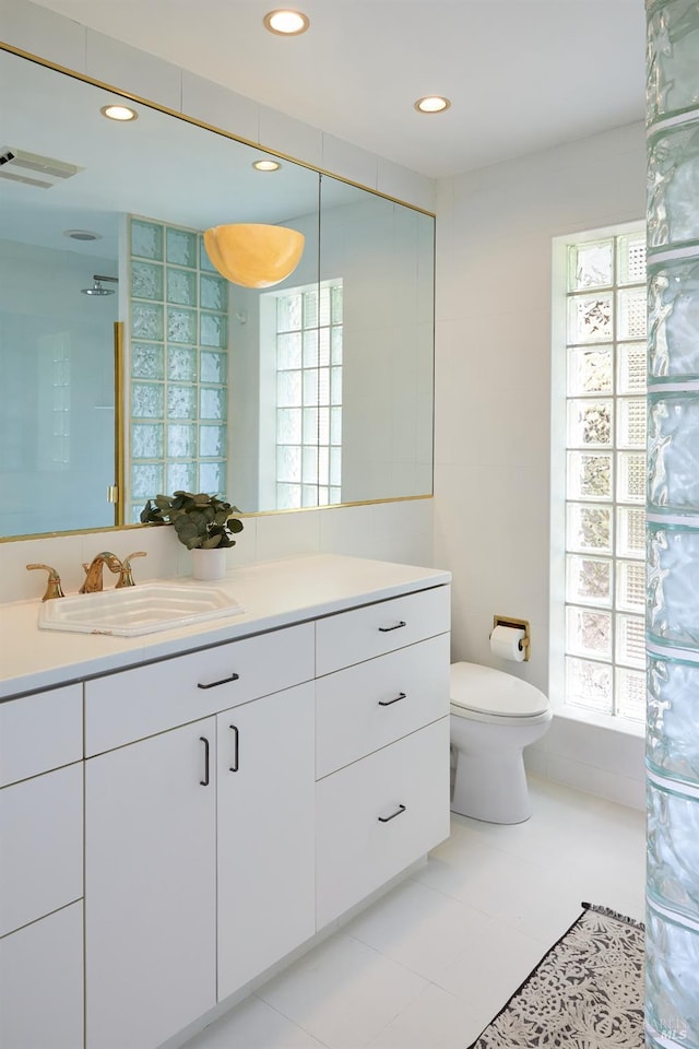 bathroom with tile patterned floors, vanity, and toilet