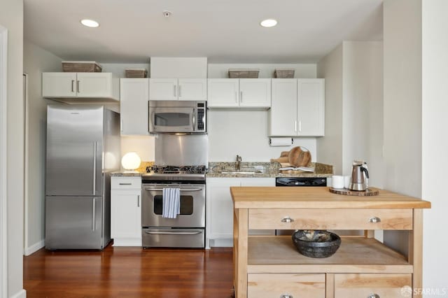 81 Frank Norris St Unit 701, San Francisco, CA 94109 - kitchen with appliances with stainless steel finishes, light stone counters, white cabinetry, and recessed lighting