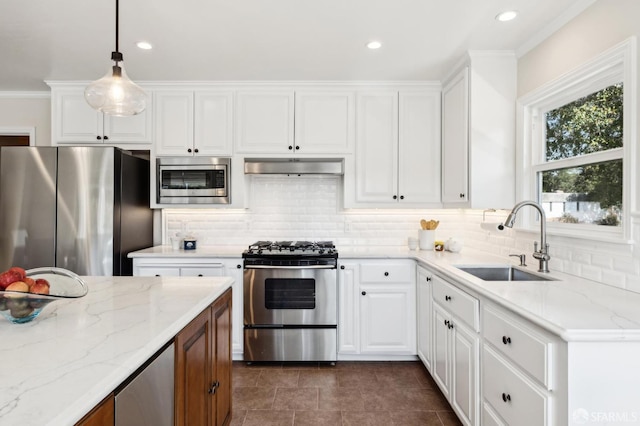 kitchen featuring under cabinet range hood, decorative backsplash, stainless steel appliances, and a sink