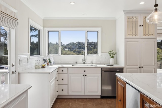 kitchen with dishwasher, crown molding, light stone counters, and a sink