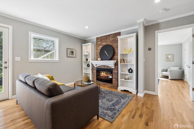 living room with baseboards, ornamental molding, and light wood finished floors