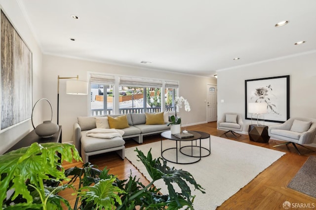 living room with recessed lighting, visible vents, wood finished floors, and ornamental molding