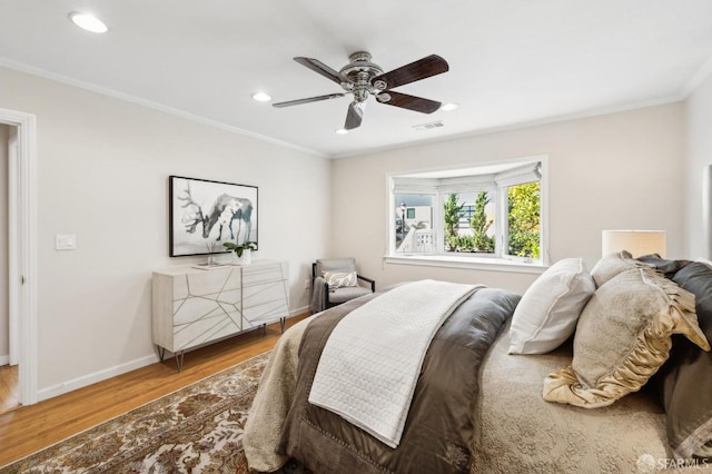 bedroom featuring visible vents, wood finished floors, recessed lighting, crown molding, and baseboards