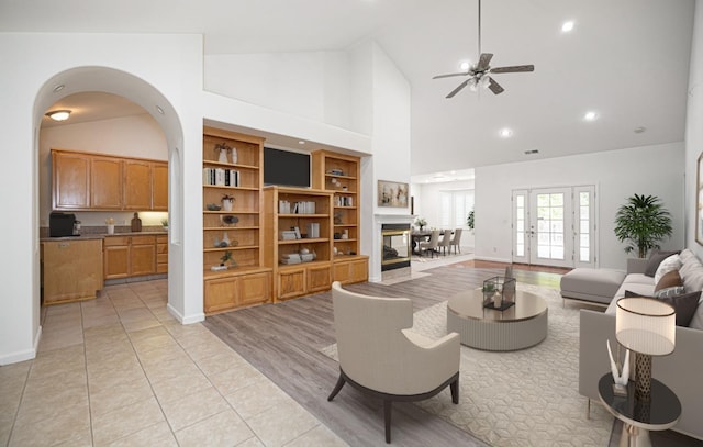 living area featuring ceiling fan, high vaulted ceiling, recessed lighting, baseboards, and visible vents
