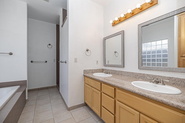 full bathroom with a sink, tile patterned flooring, tiled tub, and double vanity