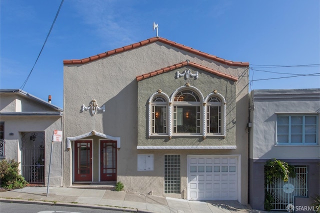 view of front of house with stucco siding and an attached garage