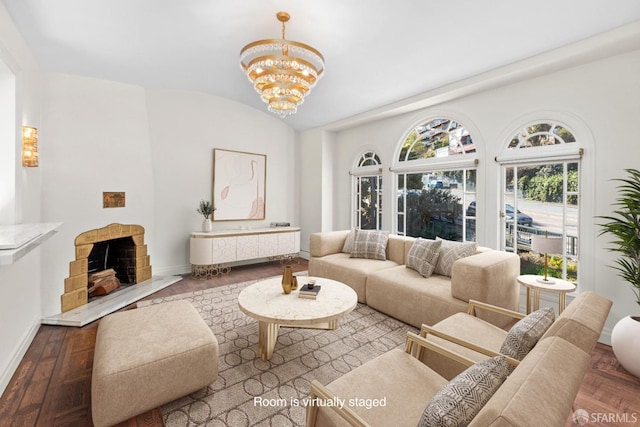 living room featuring baseboards, wood-type flooring, a chandelier, and vaulted ceiling