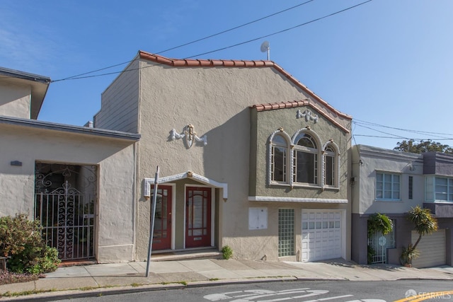 view of front facade featuring stucco siding and an attached garage