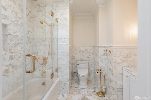 full bath with enclosed tub / shower combo, wainscoting, crown molding, toilet, and tile walls